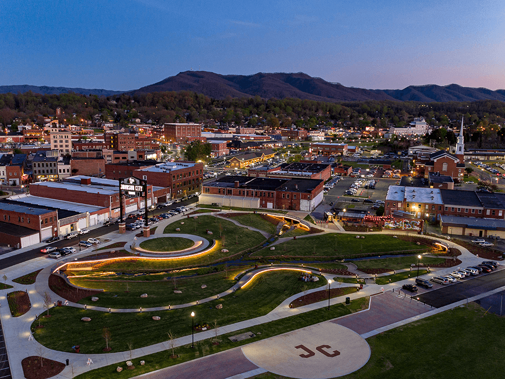 Aerial view of downtown Johnson City, Tennessee at dusk with Founders Park and surrounding mountains